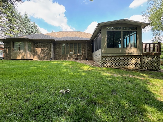 70173 Hillside Ct, Romeo, MI 48065 - back of house featuring a sunroom, a lawn, and brick siding
