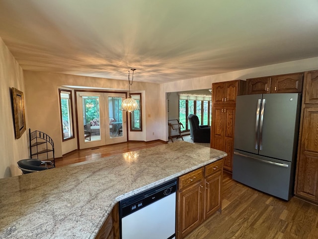 70173 Hillside Ct, Romeo, MI 48065 - kitchen featuring freestanding refrigerator, white dishwasher, dark wood-style floors, and a chandelier