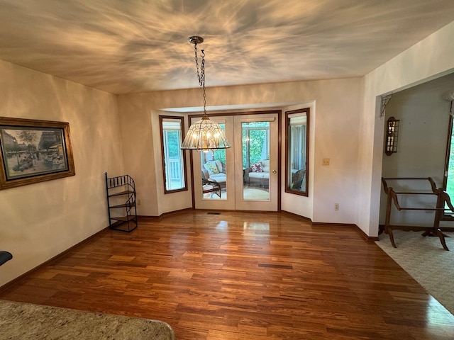 70173 Hillside Ct, Romeo, MI 48065 - unfurnished dining area featuring dark wood-style flooring and a chandelier