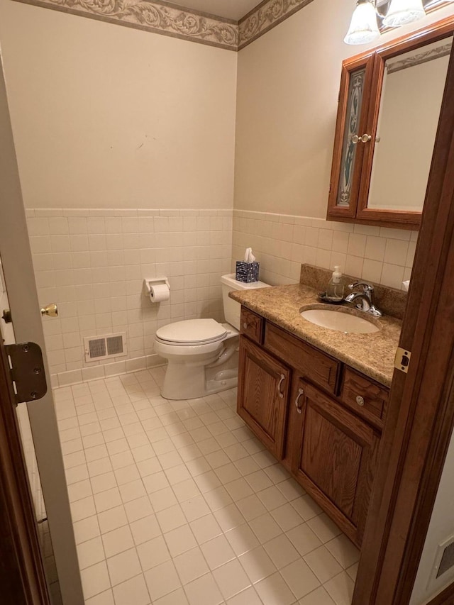 70173 Hillside Ct, Romeo, MI 48065 - bathroom with tile patterned floors, vanity, a wainscoted wall, and tile walls
