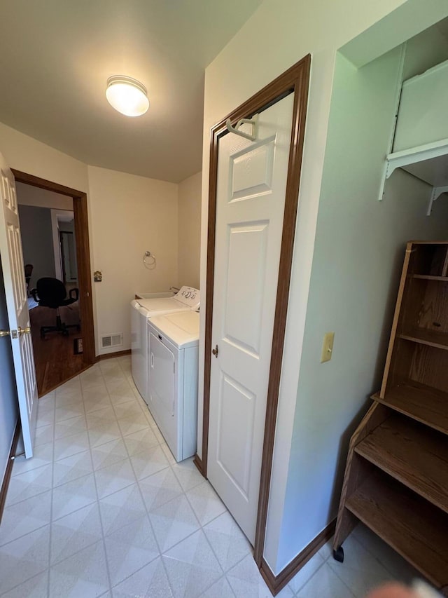 70173 Hillside Ct, Romeo, MI 48065 - laundry area with washing machine and dryer and baseboards