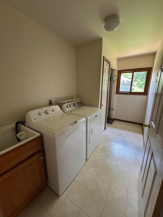70173 Hillside Ct, Romeo, MI 48065 - laundry area with washing machine and dryer, cabinet space, and light flooring