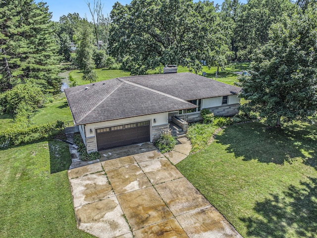 8520 Pennfield Rd, Battle Creek, MI 49017 - ranch-style home with a front yard, roof with shingles, a garage, driveway, and stone siding