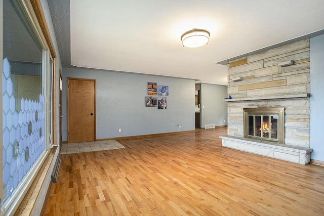8520 Pennfield Rd, Battle Creek, MI 49017 - unfurnished living room with wood finished floors and a fireplace