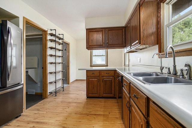 8520 Pennfield Rd, Battle Creek, MI 49017 - kitchen with freestanding refrigerator, light wood-style flooring, plenty of natural light, and light countertops