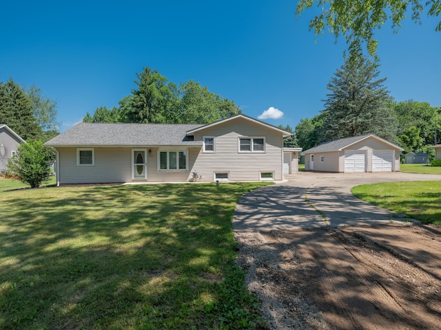 4409 E T U Ave, Vicksburg, MI 49097 - view of front of house with a garage, an outdoor structure, and a front yard