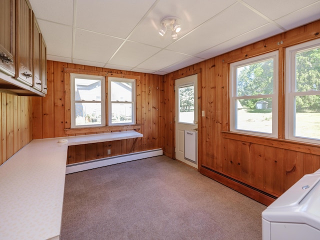 4409 E T U Ave, Vicksburg, MI 49097 - laundry area with a baseboard radiator, plenty of natural light, cabinet space, and wood walls