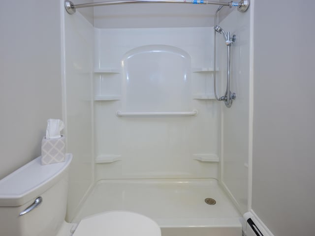 4409 E T U Ave, Vicksburg, MI 49097 - bathroom featuring a baseboard radiator and a shower