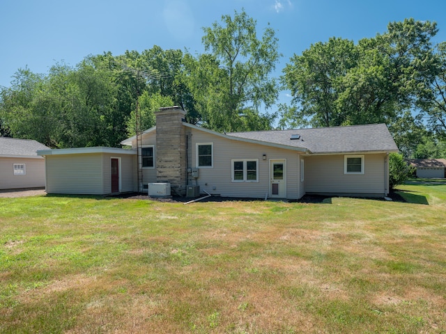 4409 E T U Ave, Vicksburg, MI 49097 - back of house with a yard and a chimney