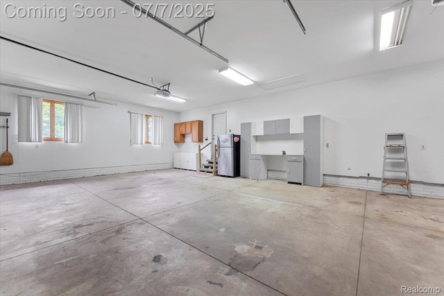 22069 Inkster Rd, Flat Rock, MI 48174 - garage featuring freestanding refrigerator and a garage door opener