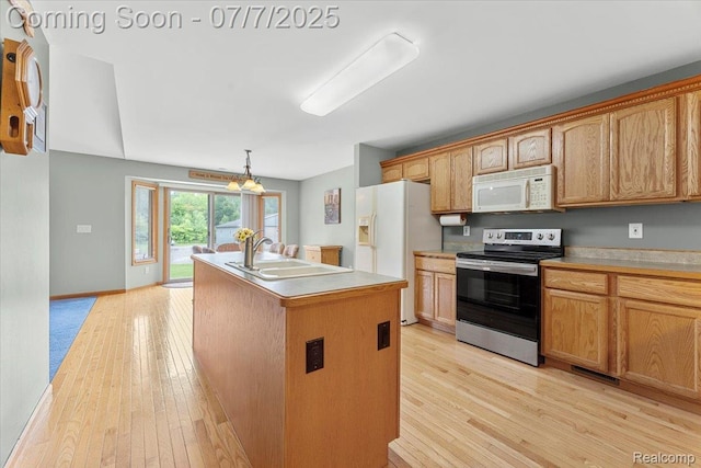 22069 Inkster Rd, Flat Rock, MI 48174 - kitchen featuring white appliances, light wood-style floors, a center island with sink, a chandelier, and light countertops