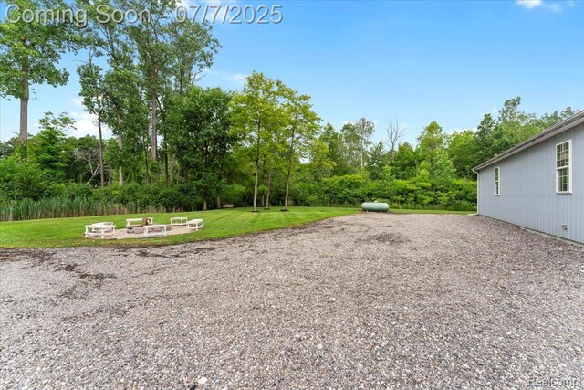 22069 Inkster Rd, Flat Rock, MI 48174 - view of grassy yard featuring view of wooded area