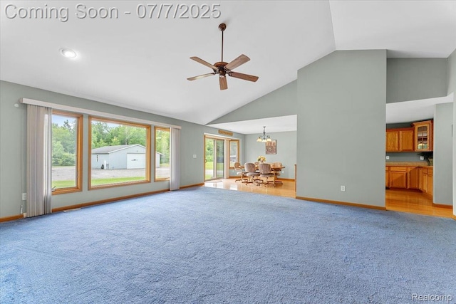 22069 Inkster Rd, Flat Rock, MI 48174 - unfurnished living room featuring light colored carpet, high vaulted ceiling, a ceiling fan, and a chandelier