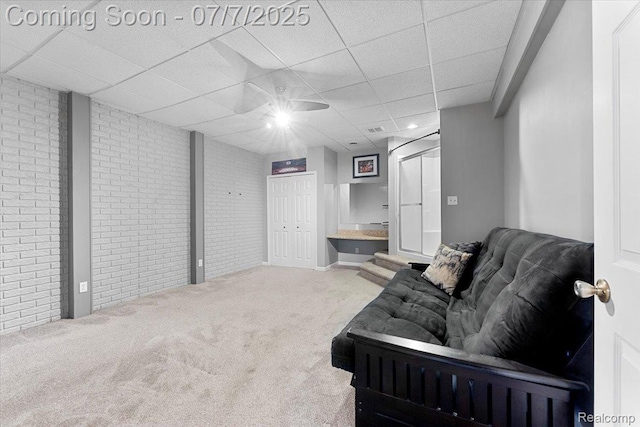 22069 Inkster Rd, Flat Rock, MI 48174 - carpeted living area featuring brick wall, a drop ceiling, and ceiling fan
