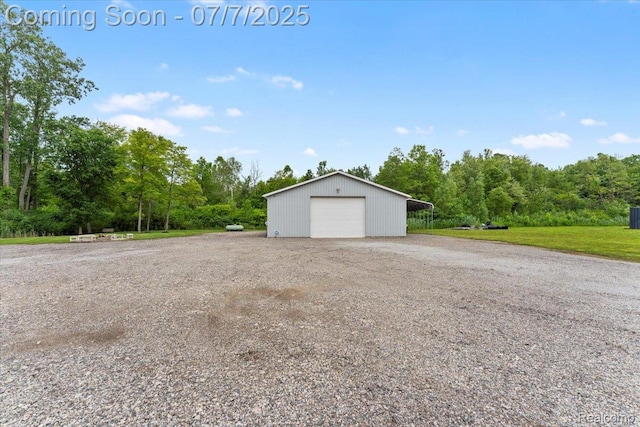 22069 Inkster Rd, Flat Rock, MI 48174 - garage featuring a detached garage, gravel driveway, and a wooded view