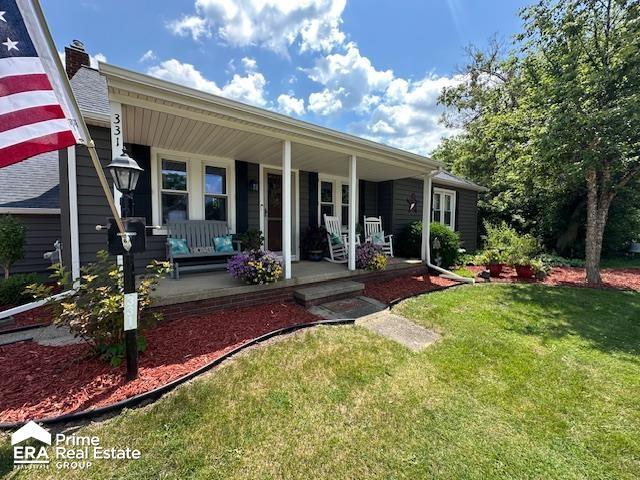 331 S St, Ortonville, MI 48462 - view of front facade with a porch and a front yard