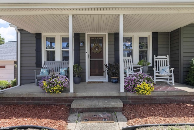 331 S St, Ortonville, MI 48462 - doorway to property featuring a porch