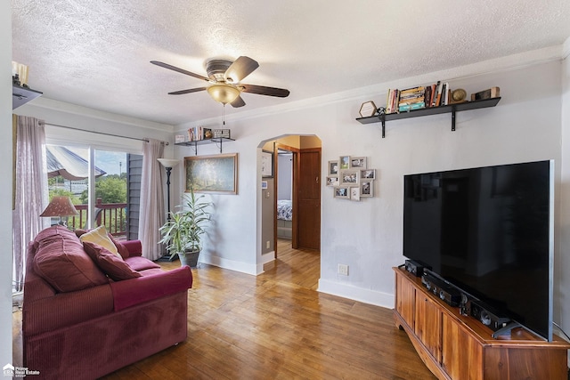 331 S St, Ortonville, MI 48462 - living area featuring arched walkways, ceiling fan, a textured ceiling, hardwood / wood-style floors, and ornamental molding