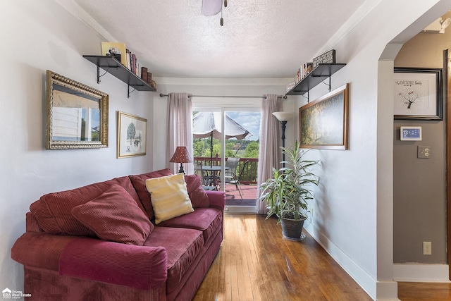 331 S St, Ortonville, MI 48462 - living room with a textured ceiling, hardwood / wood-style floors, and crown molding