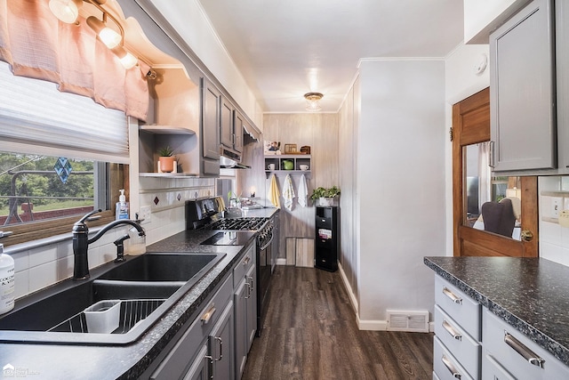 331 S St, Ortonville, MI 48462 - kitchen featuring range with gas cooktop, open shelves, dark wood finished floors, backsplash, and under cabinet range hood