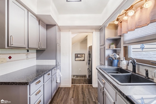331 S St, Ortonville, MI 48462 - kitchen featuring dark wood-type flooring, decorative backsplash, gray cabinets, open shelves, and freestanding refrigerator