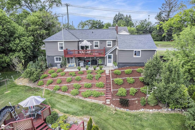 331 S St, Ortonville, MI 48462 - rear view of house featuring a wooden deck, a patio area, a shingled roof, a lawn, and a chimney