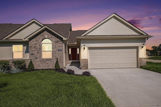 5391 Swan Ln, Burton, MI 48509 - ranch-style house featuring brick siding, a yard, driveway, a garage, and a shingled roof
