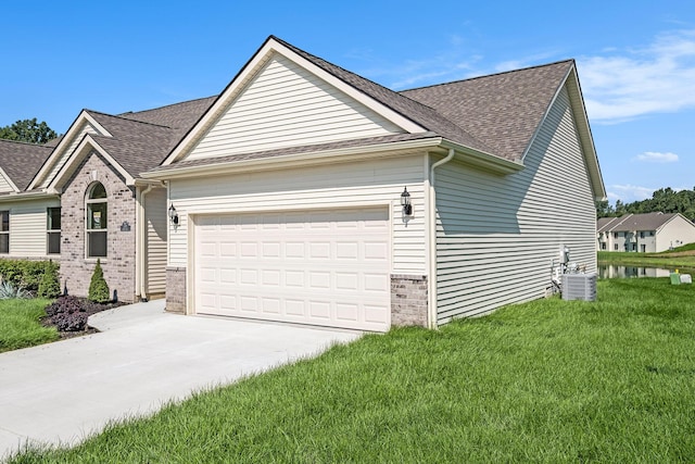 5391 Swan Ln, Burton, MI 48509 - view of property exterior with brick siding, an attached garage, roof with shingles, and driveway