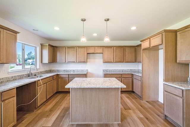 5391 Swan Ln, Burton, MI 48509 - kitchen featuring light wood finished floors, a kitchen island, light stone counters, decorative light fixtures, and recessed lighting