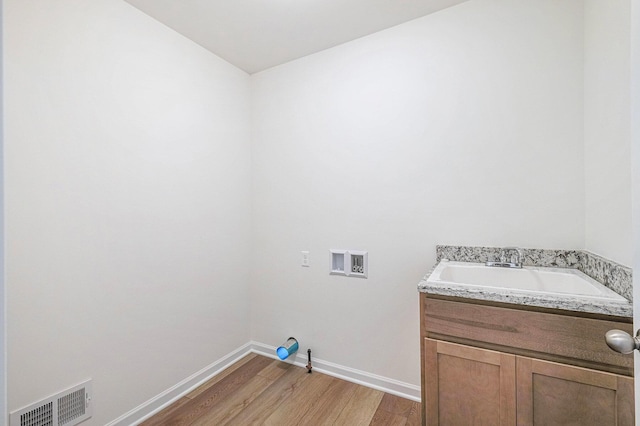 5391 Swan Ln, Burton, MI 48509 - laundry area with hookup for a washing machine and light wood finished floors