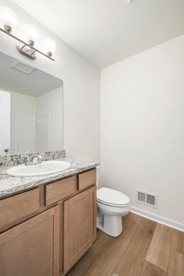 5391 Swan Ln, Burton, MI 48509 - bathroom featuring wood finished floors and vanity