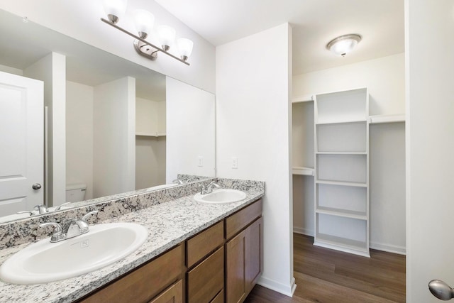 5391 Swan Ln, Burton, MI 48509 - bathroom featuring wood finished floors and double vanity