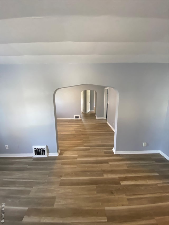 1112 Minnie St, Port Huron, MI 48060 - empty room featuring arched walkways and wood finished floors