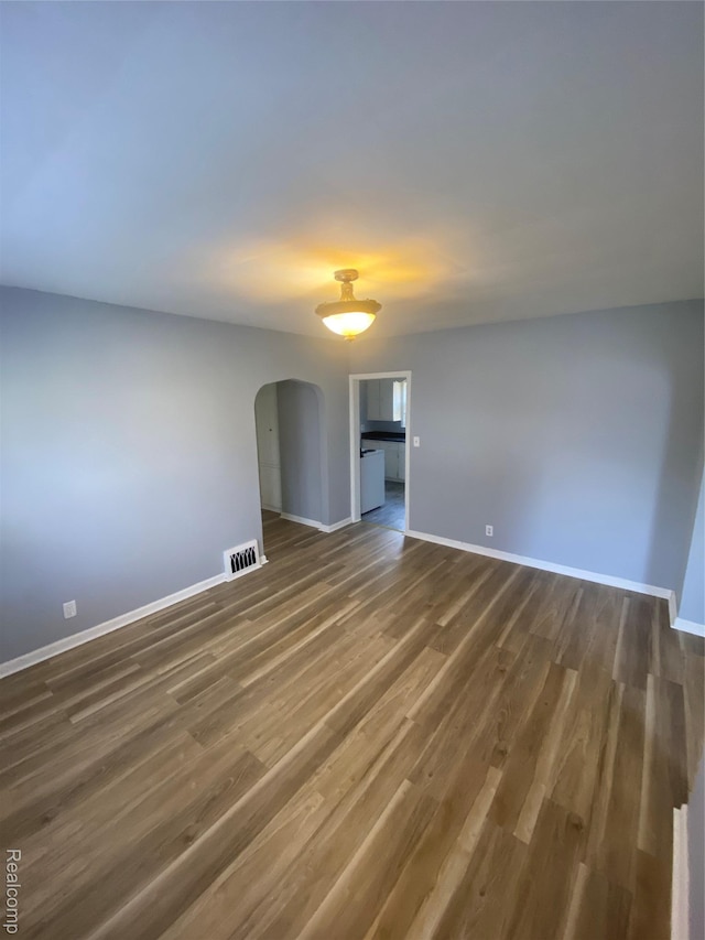 1112 Minnie St, Port Huron, MI 48060 - spare room with arched walkways and wood finished floors