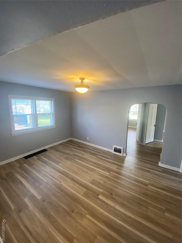 1112 Minnie St, Port Huron, MI 48060 - spare room with arched walkways and wood finished floors