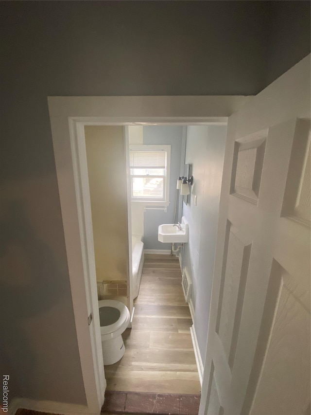 1112 Minnie St, Port Huron, MI 48060 - bathroom with toilet and wood finished floors