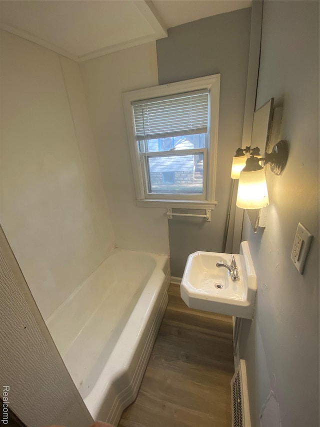 1112 Minnie St, Port Huron, MI 48060 - full bathroom featuring wood finished floors and a bath