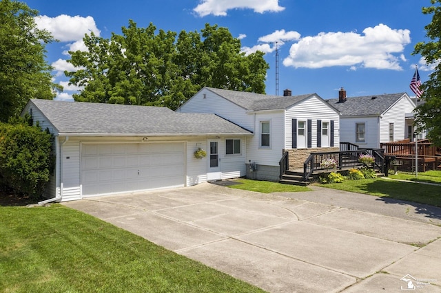 917 E 8th St, Monroe, MI 48161 - view of front of house featuring driveway, a garage, a wooden deck, a front lawn, and a shingled roof