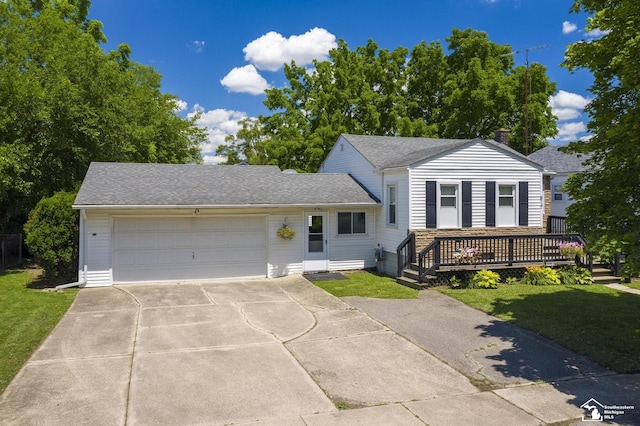 917 E 8th St, Monroe, MI 48161 - view of front of home featuring driveway, a garage, a shingled roof, and a front lawn