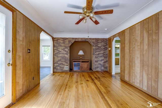 917 E 8th St, Monroe, MI 48161 - unfurnished living room with arched walkways, light wood finished floors, and a ceiling fan