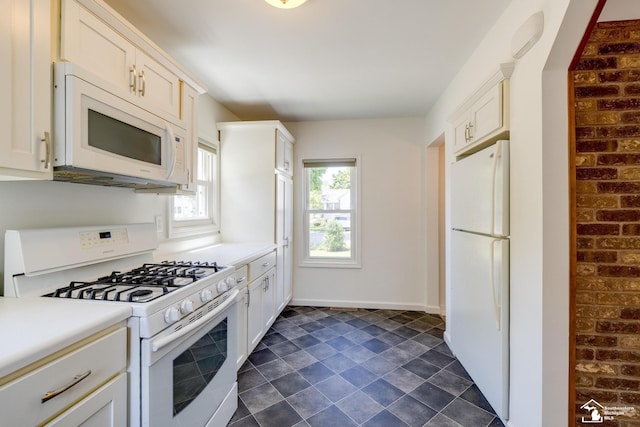917 E 8th St, Monroe, MI 48161 - kitchen with white appliances, light countertops, and white cabinetry