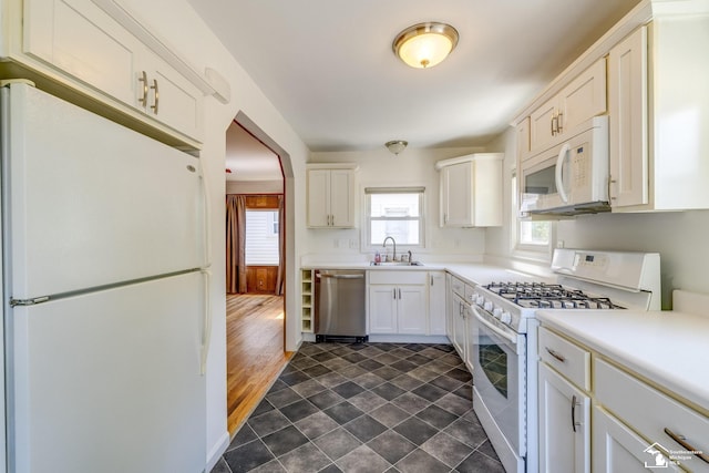 917 E 8th St, Monroe, MI 48161 - kitchen with white appliances, light countertops, and white cabinetry