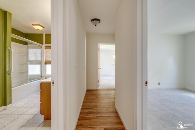 917 E 8th St, Monroe, MI 48161 - hallway with healthy amount of natural light and light tile patterned floors