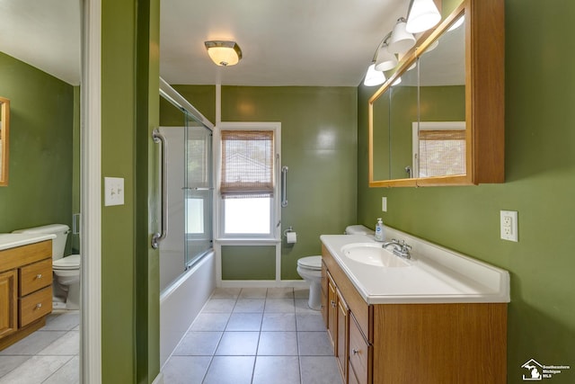 917 E 8th St, Monroe, MI 48161 - bathroom with vanity, tile patterned flooring, and combined bath / shower with glass door