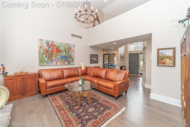 1478 Courtney Ct, Hartland, MI 48353 - living area with a chandelier, wood finished floors, a towering ceiling, and recessed lighting