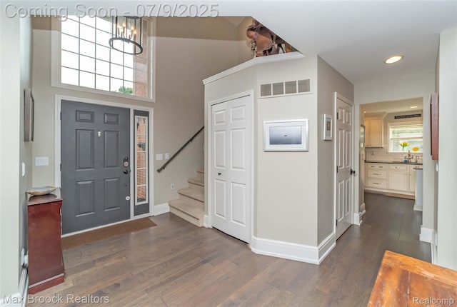 1478 Courtney Ct, Hartland, MI 48353 - entryway featuring stairway, dark wood-style floors, a chandelier, and recessed lighting