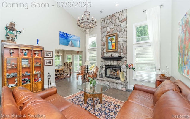 1478 Courtney Ct, Hartland, MI 48353 - living area with a chandelier, wood finished floors, a stone fireplace, and a towering ceiling