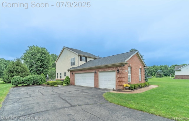 1478 Courtney Ct, Hartland, MI 48353 - view of side of home with brick siding, an attached garage, a lawn, driveway, and roof with shingles