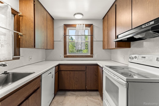 785 Tromley St, Inkster, MI 48141 - kitchen with white appliances, under cabinet range hood, light countertops, and brown cabinets