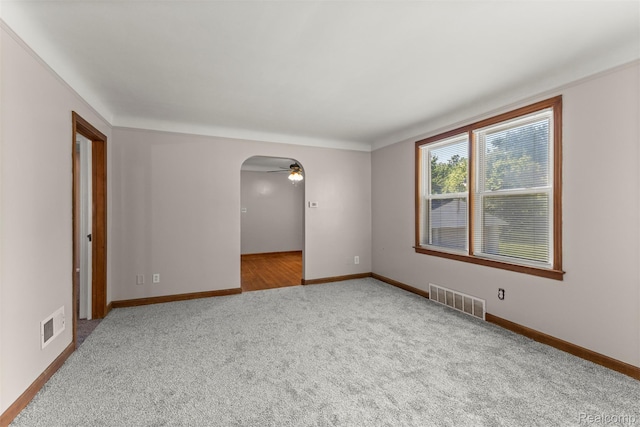 785 Tromley St, Inkster, MI 48141 - carpeted empty room with arched walkways and a ceiling fan